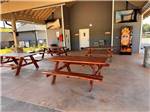 An outdoor dining area with flat screen TVs at CLEMSON RV PARK AT THE GROVE - thumbnail