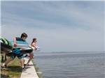 Two kids in inner tubes jumping into the ocean at OUTER BANKS WEST/CURRITUCK SOUND KOA HOLIDAY - thumbnail