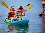 Two young ladies in a kayak at OUTER BANKS WEST/CURRITUCK SOUND KOA HOLIDAY - thumbnail