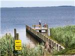 A couple at the end of the pier fishing at OUTER BANKS WEST/CURRITUCK SOUND KOA HOLIDAY - thumbnail