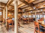 Wooden tables and chairs in the bar and grill at BLUE WATER RV RESORT - thumbnail