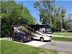 Motorhome parked in campsite at GATEWAY TO THE SMOKIES RV PARK & CAMPGROUND - thumbnail