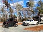 A truck and trailer in a gravel RV site at IRON MOUNTAIN RESORT - thumbnail