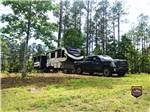 A truck and fifth wheel trailer in a primitive campsite at IRON MOUNTAIN RESORT - thumbnail