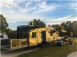 A fifth wheel toy hauler parked in a gravel site at BIGFOOT ADVENTURE RV PARK & CAMPGROUND - thumbnail