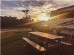 A picnic table next to a motorhome at BIGFOOT ADVENTURE RV PARK & CAMPGROUND - thumbnail