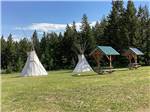 Two teepees with picnic tables at RED EAGLE CAMPGROUND - thumbnail