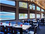 Dining area under high vaulted ceiling with big windows at BIG ARM RESORT & CASINO - thumbnail
