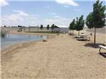 A water area next to picnic benches at BONNIE & CLYDE'S GETAWAY RV PARK - thumbnail
