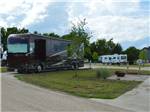 RVs parked in camping spaces at HIDDEN GROVE RV RESORT - thumbnail