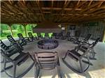 Rocking chairs surrounding a fire ring at PINE CREEK CABINS AND CAMPGROUND - thumbnail