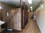 Restroom stalls with tiled floor at PINE CREEK CABINS AND CAMPGROUND - thumbnail
