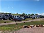 A row of RVs and cars parked in sites at SUNRISE RIDGE CAMPGROUND - thumbnail