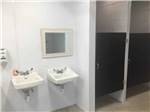 Bathroom with two sinks and mirror at KUMBERLAND CAMPGROUND - thumbnail