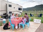 People eating around a table at ALPINE VALLEY RV RESORT - thumbnail