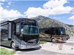 Two motorhomes parked on-site at ALPINE VALLEY RV RESORT - thumbnail