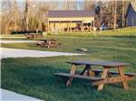 Picnic tables next to paved RV sites at WHISPERING FALLS RV PARK AND STORE - thumbnail