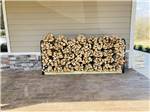 A stack of firewood for sale at WHISPERING FALLS RV PARK AND STORE - thumbnail