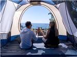 Couple enjoying drinks inside a tent at FLYING FLAGS AVILA BEACH - thumbnail