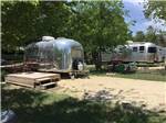 Sandy campsites and several campers at OFF THE VINE RV PARK - thumbnail