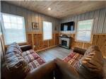 Living room and fireplace in luxury suite at BRUSHCREEK FALLS RV RESORT - thumbnail