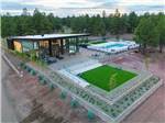 Aerial view over the lobby, swimming pool and green area at VILLAGE CAMP FLAGSTAFF - thumbnail