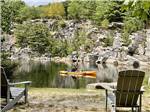 Kayaker on the water with Adirondack chairs overlooking at HTR ACADIA - thumbnail