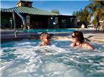 A couple relaxing in a hot tub at PECHANGA RV RESORT - thumbnail