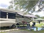 A fifth wheel trailer with its awning out at CAMPGROUNDS OF THE SOUTH - thumbnail