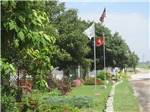 Flagpoles at entrance at PINE GROVE RV PARK - thumbnail
