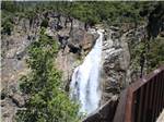 View of a waterfall from a bridge at RIVER REFLECTIONS RV PARK & CAMPGROUND - thumbnail