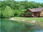 Cabin overlooking a placid pond at DENTON FERRY RV PARK & CABIN RENTAL - thumbnail