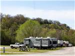Row of RV campsites at the foot of a hill at DENTON FERRY RV PARK & CABIN RENTAL - thumbnail