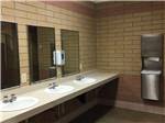 Clean bathroom with 3 sinks at HEYBURN RIVERSIDE RV PARK - thumbnail