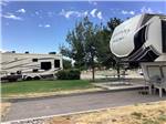 Fifth-wheel parked in paved campsite with picnic table at HEYBURN RIVERSIDE RV PARK - thumbnail