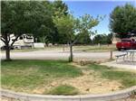 Picnic table at campsite with red truck in background at HEYBURN RIVERSIDE RV PARK - thumbnail