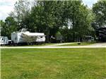 A grassy lawn next to a group of RV sites at COUNTRYSIDE CAMPGROUND - thumbnail