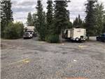 RVs in a group of gravel sites surrounded by trees at NORTHERN NIGHTS CAMPGROUND - thumbnail