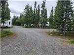 A rounded gravel road into the sites at NORTHERN NIGHTS CAMPGROUND - thumbnail
