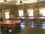 Dining area with large red tables at J & J RV PARK - thumbnail