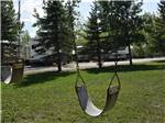 Swing set with RVs in the background at ARROWHEAD RV PARK - thumbnail