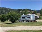 A trailer in a gravel RV site at YELLOWSTONE HOLIDAY RV CAMPGROUND & MARINA - thumbnail