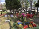 RV parked in site with cornhole game and seating area at LAKE CITY RV RESORT - thumbnail