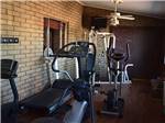Exercise room with treadmill and elliptical machines at PHOENIX METRO RV PARK - thumbnail