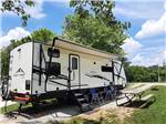 A trailer in a RV site at SINGING HILLS RV PARK - thumbnail
