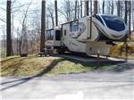 A fifth wheel trailer in a paved RV site at RIFRAFTERS CAMPGROUND - thumbnail