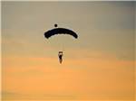 Person hang gliding at dusk at ROBERT NEWLON RV PARK - thumbnail