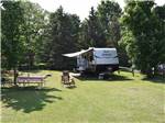 A travel trailer surrounded by grass at SAUGEEN SPRINGS RV PARK - thumbnail