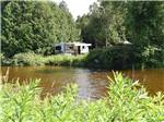A travel trailer near banks of a stream at SAUGEEN SPRINGS RV PARK - thumbnail