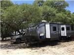 Travel trailer under a tree at CASCADE CAVERNS & CAMPGROUND - thumbnail
